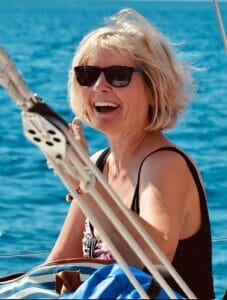 Smiling Lori Gradley on a boat enjoying freedom and positive mindset